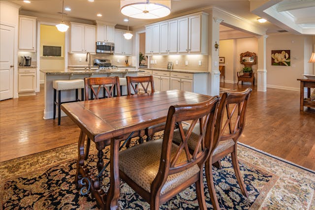 cozy living room and kitchen with wooden and white furniture